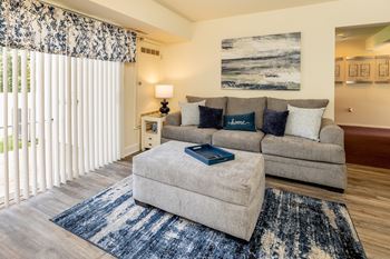 a living room with a gray couch and a blue rug at Seven Oaks Townhomes, Edgewoode, MD, 21040